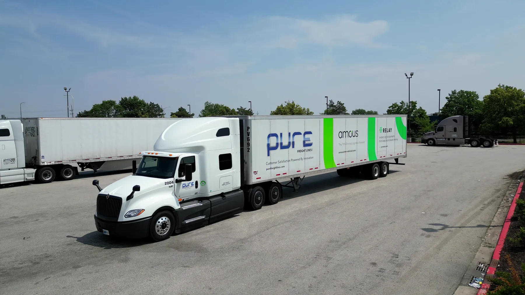 Pure Freight Lines truck and trailer crossing the yard, seen from a drone